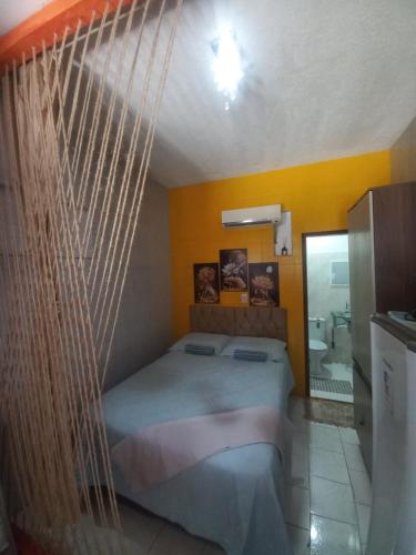 a bed in a room with a hanging bed at Aracaju Suite - Seu Conforto no Coração da Capital in Aracaju