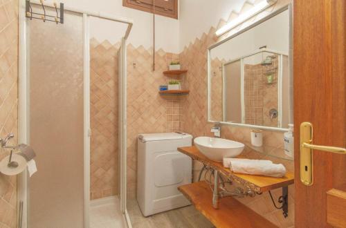 a bathroom with a toilet and a sink and a shower at Attico Stella Maris in Palau