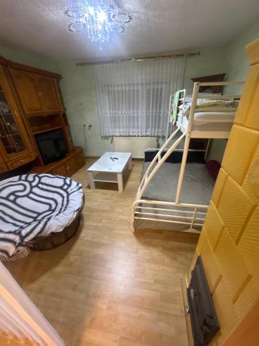 a room with two bunk beds and a table at Blaureisen Gasthaus in Zschepplin