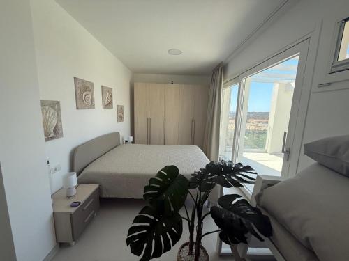 Ένα ή περισσότερα κρεβάτια σε δωμάτιο στο Acquamarina Apartment