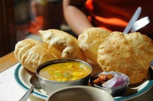 a plate of food with biscuits and dipping sauce at Hotel Grand C & G at Central Delhi New Delhi in Jāmb