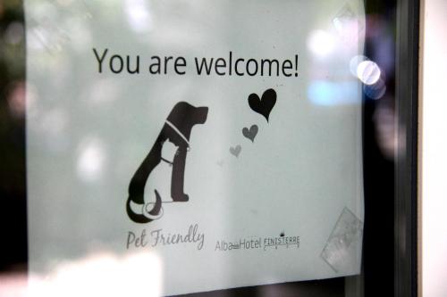 a sign that says you are welcome with a dog at Alba Hotel in Marina di Ravenna