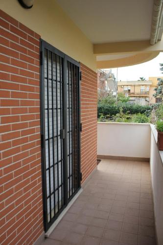 an entrance to a brick building with black doors at The Mazzitellis Home in Nettuno