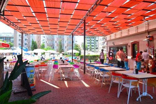 a group of tables and chairs on a patio at Club Sidar Apart Hotel in Alanya