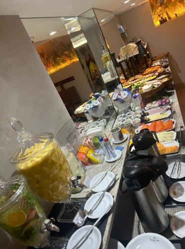 uma fila de buffet com comida numa mesa num quarto em Brisas Hotel Style em Cuiabá