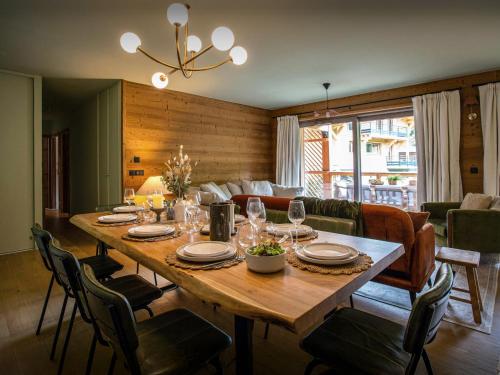 a dining room with a table with wine glasses at Lodge Cresson - OVO Network in Châtel