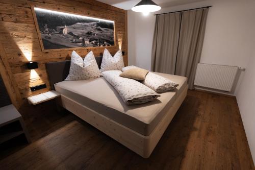 a bedroom with a bed with pillows on it at Ferienhaus Köck in Kartitsch