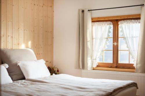 ein Schlafzimmer mit einem Bett und einem Fenster in der Unterkunft Ferienwohnung Firstblick in Egg