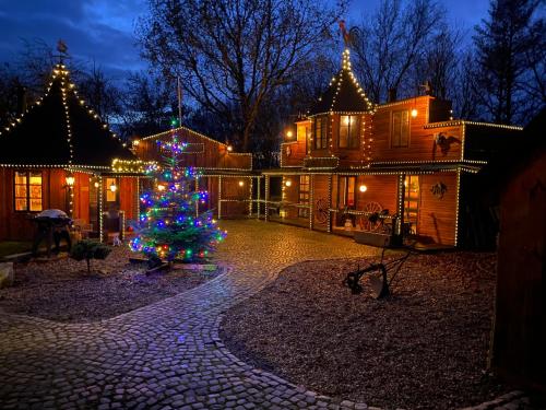 a christmas tree in the yard of a house at Klondike City in Vojens