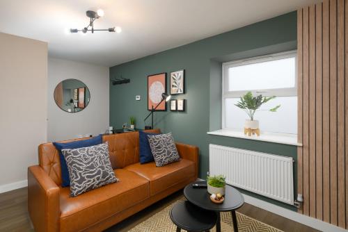 a living room with a couch and a table at CityPad2 Stylish City Centre 2BR Apartment with Free Parking & WIFI in Cardiff