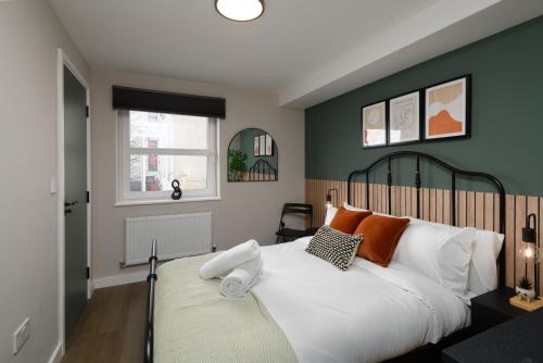 a bedroom with a large bed and a window at CityPad2 Stylish City Centre 2BR Apartment with Free Parking & WIFI in Cardiff