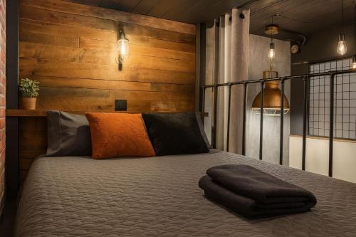 a bedroom with a bed with a black blanket on it at Loft Style Industriel Centre ville Parking Gratuit in Quebec City