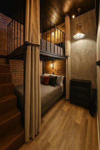 a bedroom with a bunk bed and a staircase at Loft Style Industriel Centre ville Parking Gratuit in Quebec City