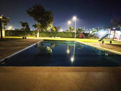 a swimming pool in a park at night at Las Palmas in Concepción del Valle