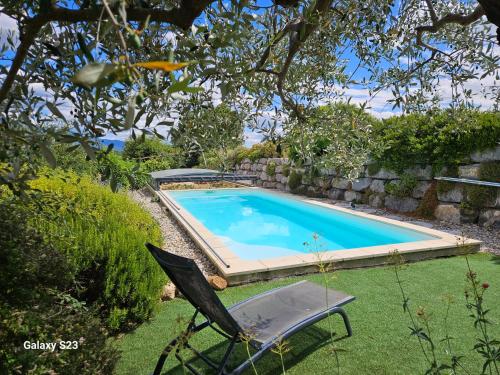 a chair sitting next to a swimming pool at gite ventoux in Puyméras
