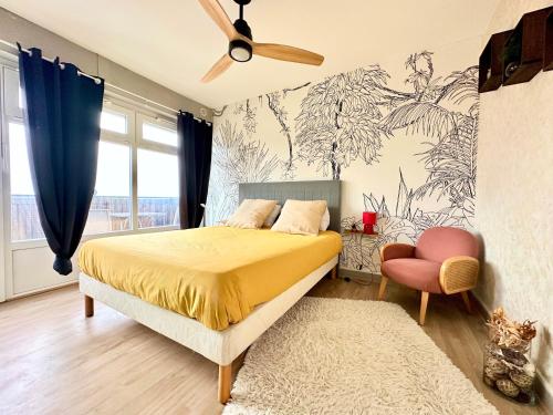 a bedroom with a bed and a ceiling fan at La Bulle Gambetta in Angoulême
