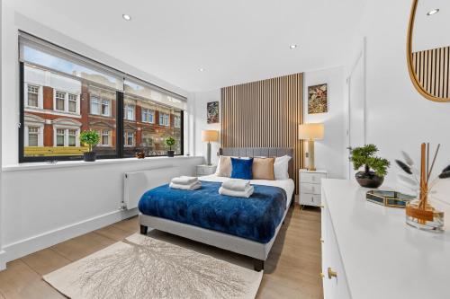 a white bedroom with a bed and a window at Luxury Two Bedroom Living - Central London & Westminster in London