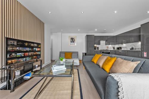 a living room with a gray couch and yellow pillows at Luxury Two Bedroom Living - Central London & Westminster in London