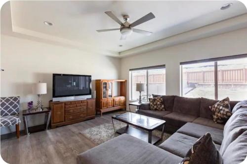 a living room with a couch and a flat screen tv at Sweet stay near Denver airport in DEN