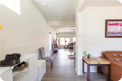a living room with white walls and a dining room at Sweet stay near Denver airport in DEN
