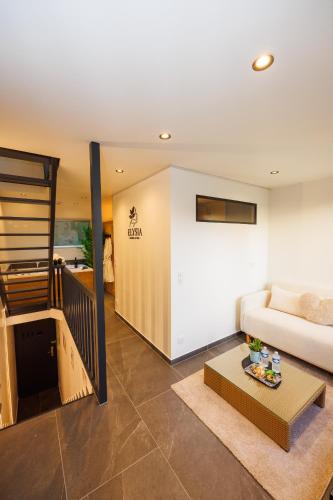 a living room with a couch and a table at ELYSIA Nature & Spa in Boersch