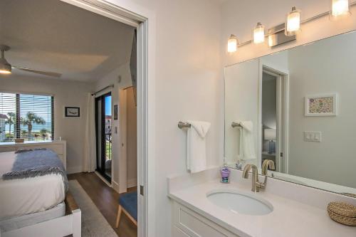 a bathroom with a sink and a mirror and a bed at 3rd Story Sanibel Condo With Coastline Views 3C3 in Sanibel
