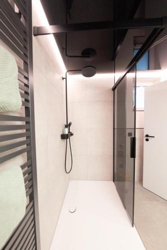 a shower with a glass door in a bathroom at kleines KunzGlück in Waldbronn