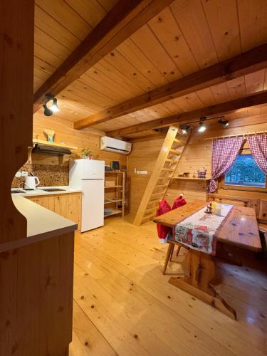 a kitchen with a table in the middle of a room at Cottage Ladybug in Mojstrana