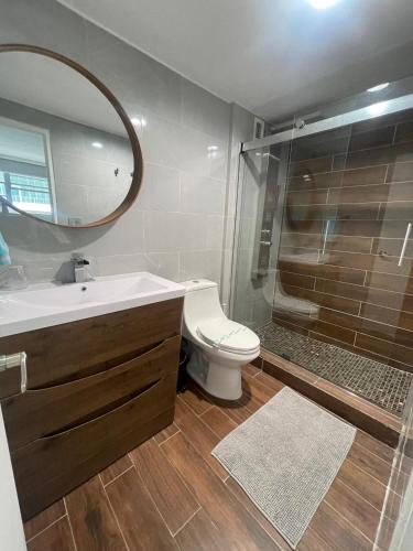 a bathroom with a sink and a toilet and a mirror at Ocean view Hollywood in Hollywood