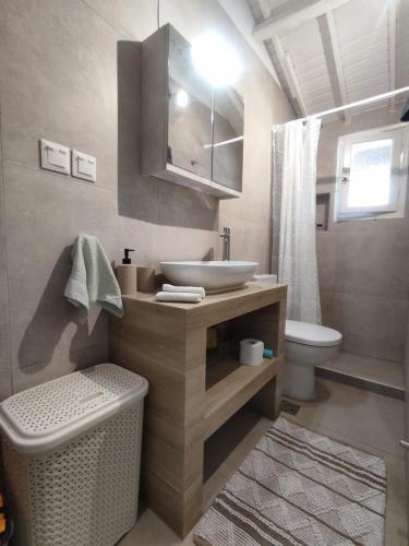 a bathroom with a sink and a toilet at Our Summer Nest in Panormos Skopelos