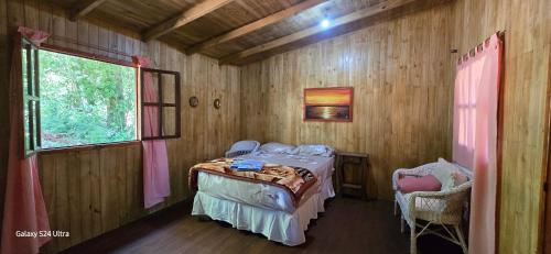 a small room with a bed and a window at Cabañas de los árboles in Puerto Esperanza