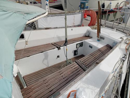 a boat with a wooden deck on the front at Voilier au Port de Perros-Guirec in Perros-Guirec