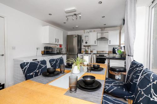 a kitchen with a table with dishes on it at Home from Home in Leicester