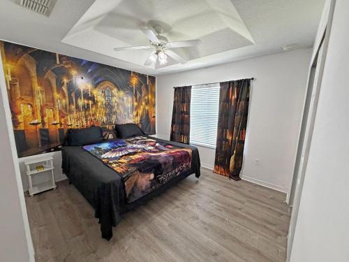 a bedroom with a bed with a painting on the wall at Paradise Cay Resort - Near to Disney in Kissimmee