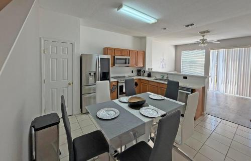 a kitchen with a table and chairs and a kitchen with at Paradise Cay Resort - Near to Disney in Kissimmee