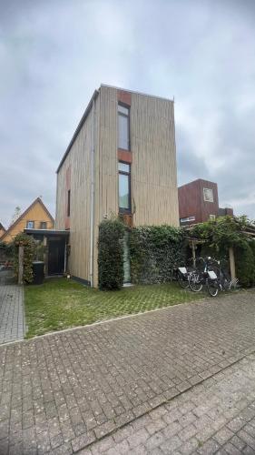 a house with a motorcycle parked in front of it at Two nice rooms in residential area with private bathroom in Almere
