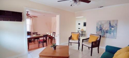 a living room with a couch and a table at House Close to Downtown, Airport, Raymond James Stadium, and Many More Places in Tampa
