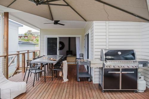 un patio con una mesa y una parrilla en una terraza en The Lake Escape, en Yatte Yattah