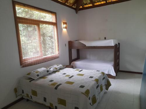 a bedroom with a bed and a bunk bed at Fernando e Fernanda in Itupeva