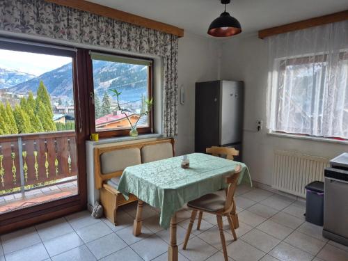 kuchnia ze stołem oraz balkon z widokiem w obiekcie Apartment Ad Alta - Flattach w mieście Flattach