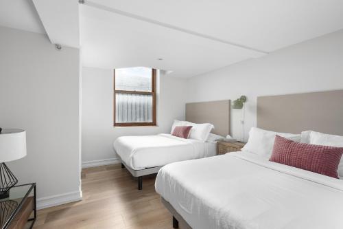 Postel nebo postele na pokoji v ubytování Le Nomade MTL