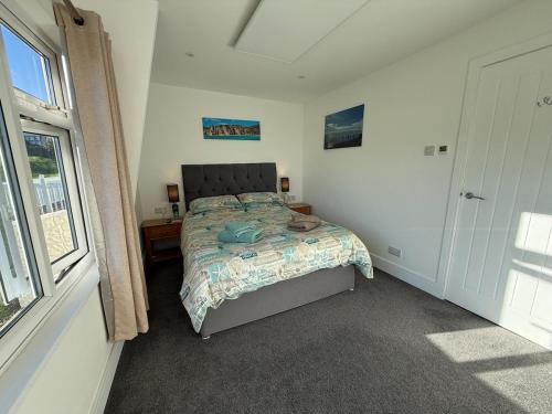 a bedroom with a bed and a window at Seagulls Rest in Isle of Wight