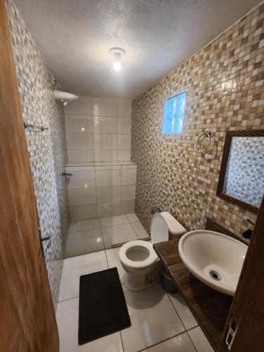 a bathroom with a toilet and a sink at Loft Iemanjá in Itacaré