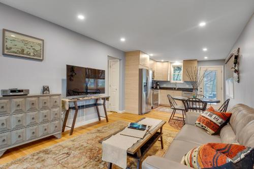 a living room with a couch and a kitchen at 2BR DOG-Friendly Apt in 2-Fam Home - Comfy Retreat in Boston