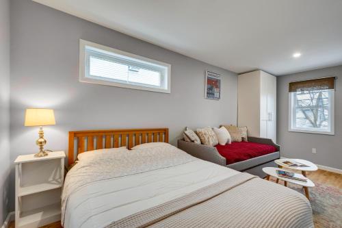 a bedroom with a bed and a couch and a window at 2BR DOG-Friendly Apt in 2-Fam Home - Comfy Retreat in Boston