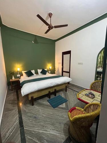 a bedroom with a bed and a ceiling fan at Tiny Spot Hostel Rishikesh in Rishīkesh