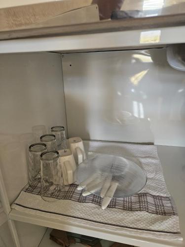 a shelf of a refrigerator with various items on it at Loft do Valle II in Sorriso