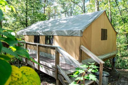 a large tent in the middle of a forest at The Green Heron's Nest - Family Glamping Tent in Red River Gorge in Rogers
