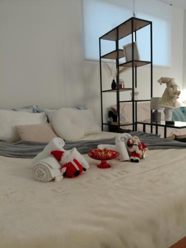 a group of stuffed animals sitting on top of a bed at S&M Cozy Garden Lagonisi in Lagonissi