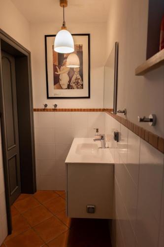 a bathroom with a white sink and a mirror at Mały Domek w Górach Sowich in Pieszyce
